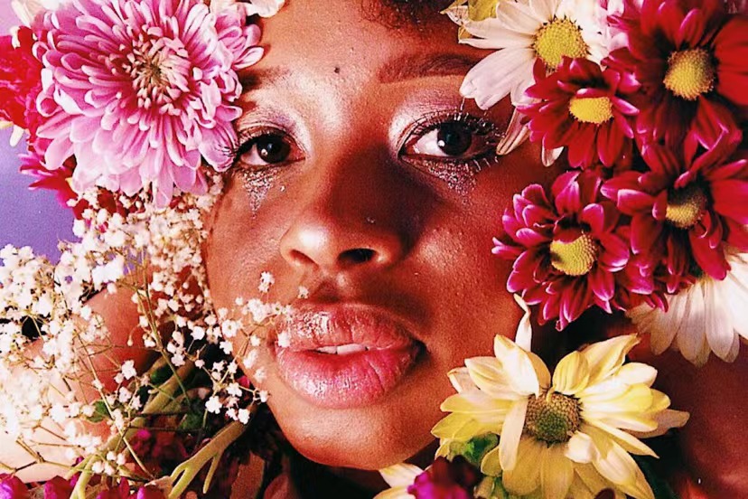 African woman with flowers.