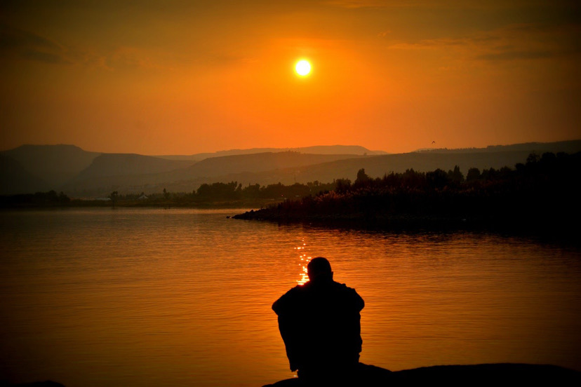 African man watching the sunset.