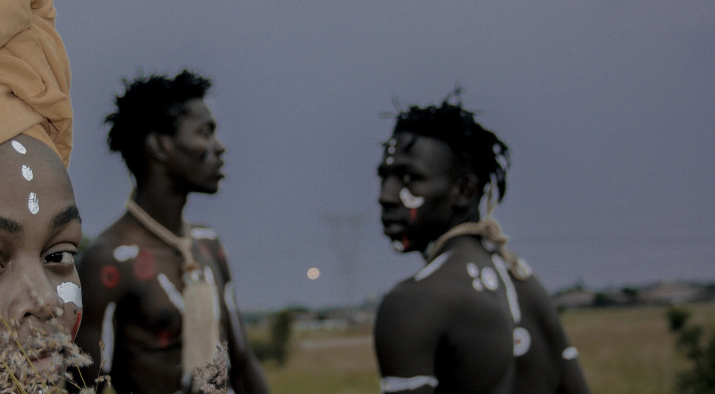 Three africans with tribal paintings on there body.
