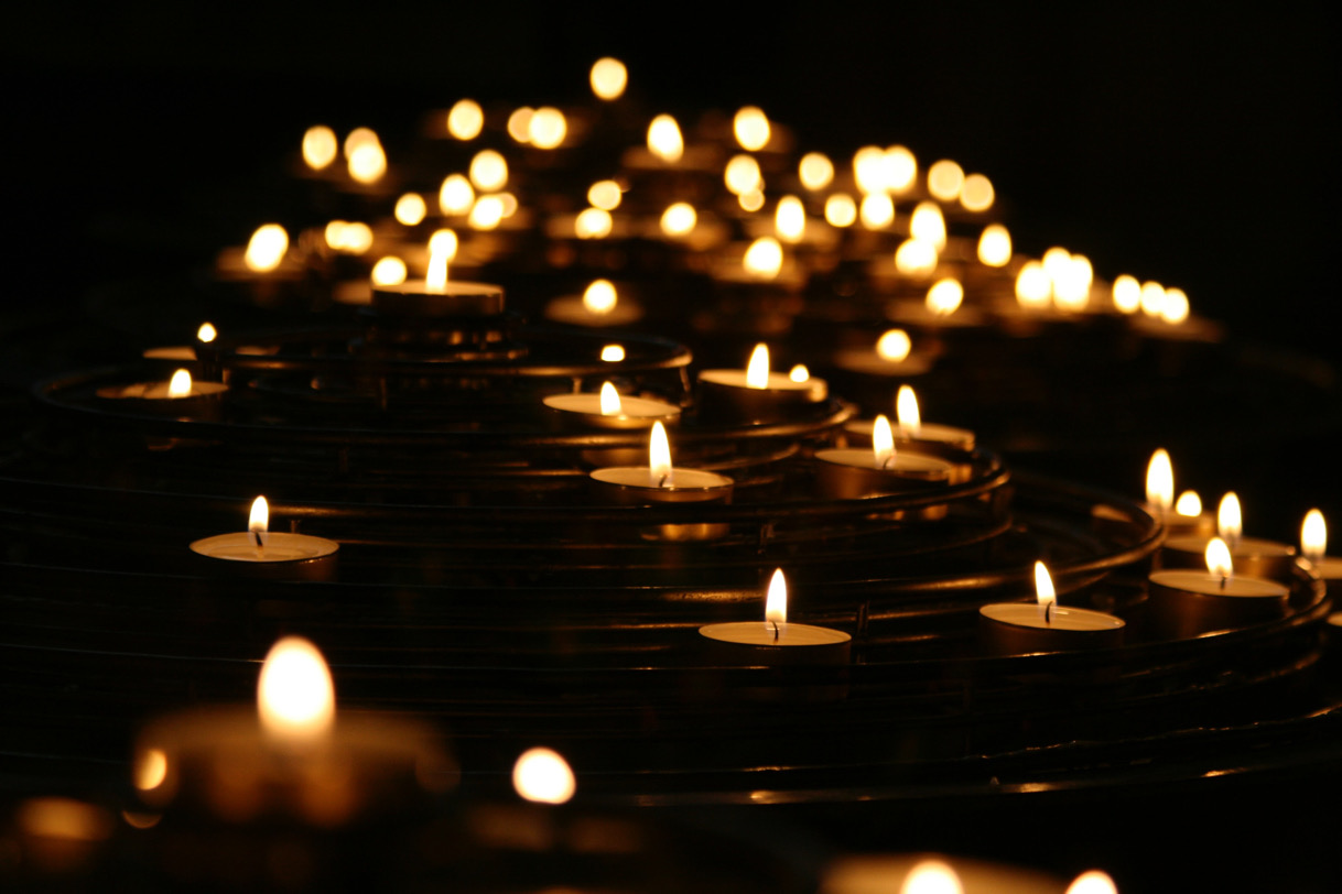 Lit candles in darkness